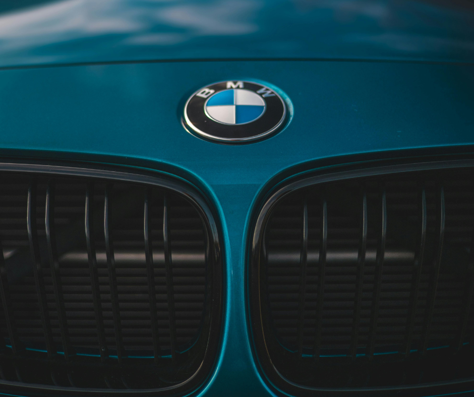 BMW roundel badge and signature kidney grilles on teal blue vehicle