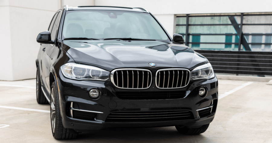 Black BMW X5 front grille and headlight detail parked in garage