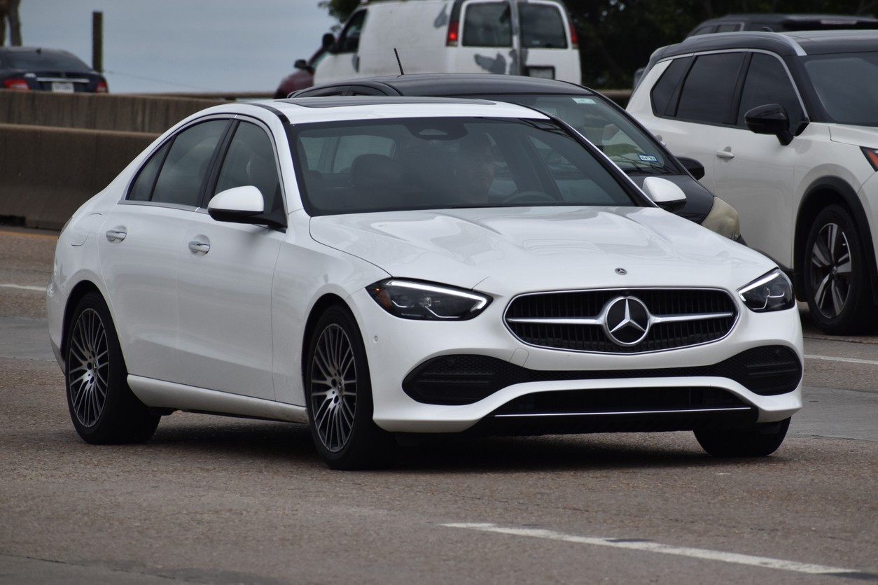 White Mercedes-Benz sedan on the road, representing expert maintenance services to keep vehicles road-ready in Alberta’s extreme weather conditions.