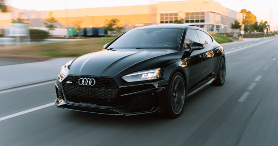 Black Audi RS5 Sportback driving on a city street