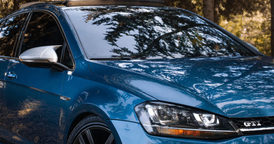 Blue Volkswagen GTI front quarter panel and headlight close-up