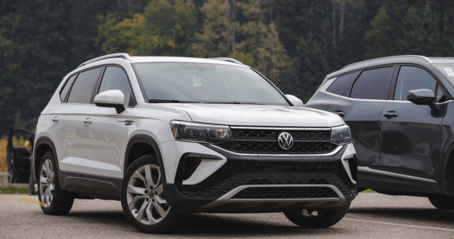 White Volkswagen Taos front grille and badge in parking lot